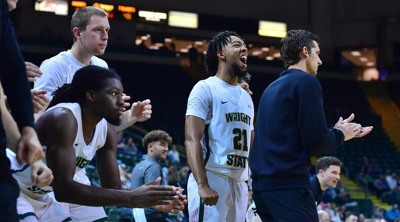 Wright State players, including Logan Woods (21), and coach Clint Sargent on the sidelines during their home-opening win over Ohio Christian in November of 2024. JOSEPH CRAVEN/WRIGHT STATE ATHLETICS