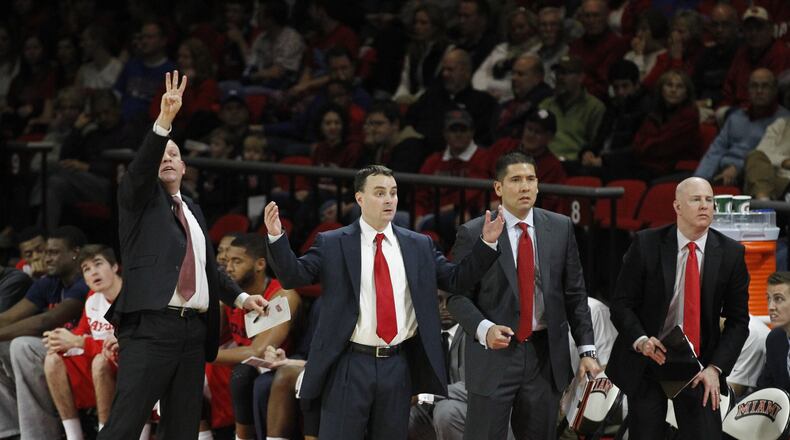Dayton coaches Kevin Kuwik, left, Archie Miller, Tom Ostrom and Bill Comar, right, watch the action on Wednesday, Dec. 3, 2014, at Millett Hall in Oxford. David Jablonski/Staff