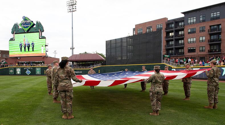 Airmen from Wright-Patterson Air Force Base display a large American flag during Day Air Ballpark’s American Celebration night Aug. 13. The annual Dayton Dragons tribute included military static displays, posting of the colors by WPAFB’s Honor Guard, and the swearing-in of new Air Force and Marine recruits. U.S. AIR FORCE PHOTO/JAIMA FOGG