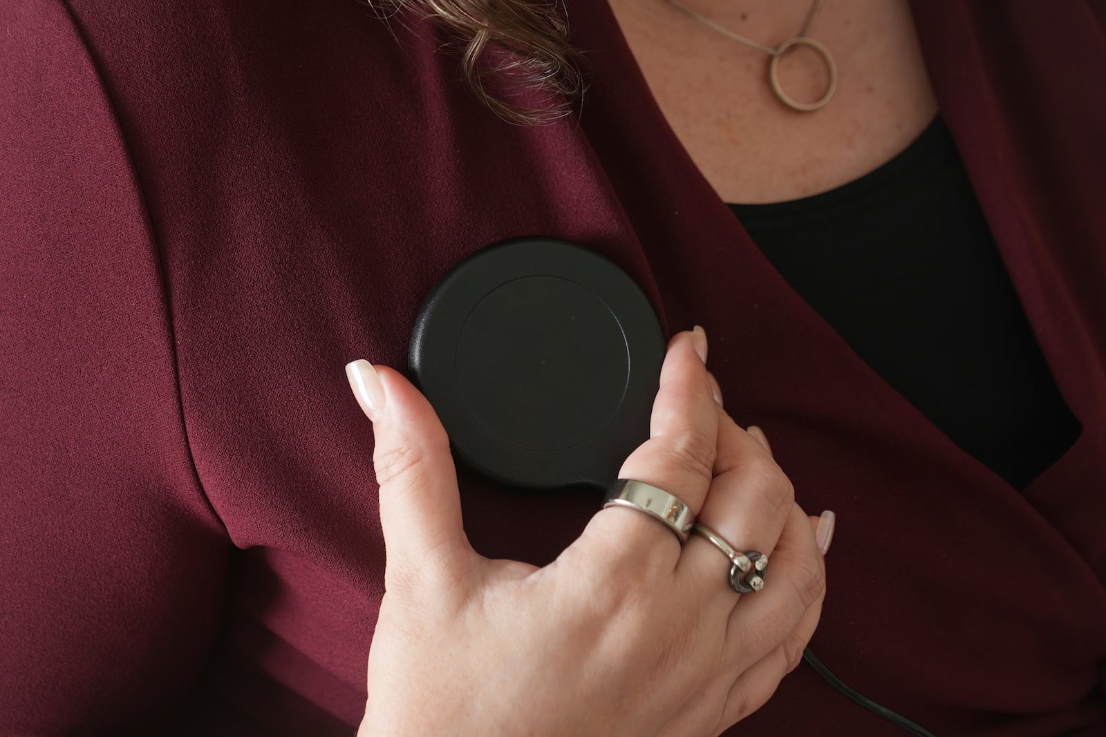 Brandy Ellis charges a pacemaker-like device that was installed in her chest as part of an experimental treatment for depression, on Thursday, July 24, 2025, in Delray Beach, Fla. (AP Photo/Marta Lavandier)