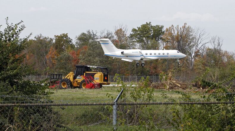 The City of Dayton is removing trees from the Wright Brothers Airport near Springboro for better runway approach clearance according to airport officials. The large trees behind this Gulfstream jet arriving at the airport last week have now been removed. Trees are also being removed near the Kauffman YMCA in Springboro. TY GREENLEES / STAFF