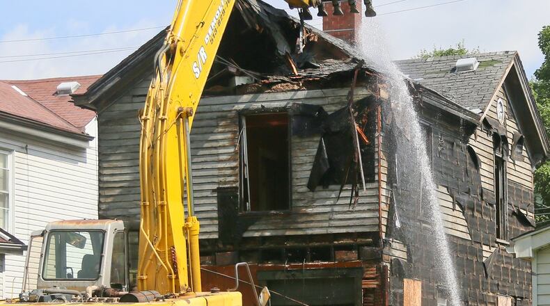 Demolition crews tear down a house in 2016. GREG LYNCH / STAFF