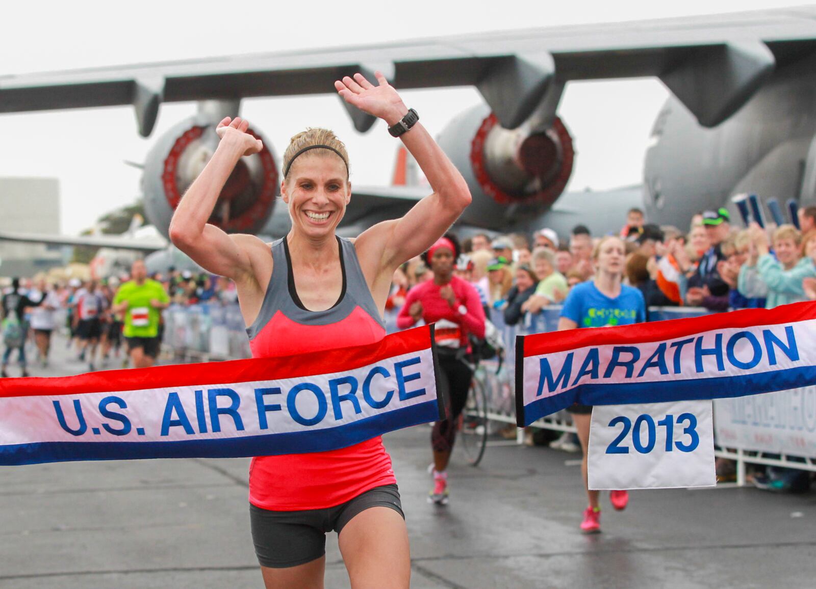 Michelle Farr of Medina crosses the finish line to win the women's full marathon event at the 17th annual Air Force Marathon on Saturday, September 21. CHRIS STEWART / STAFF