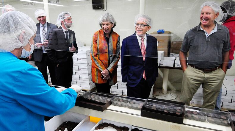 Ohio Governor Mike DeWine with first lady Fran took a tour  of Esther Price Candies with CEO Douglas Dressman, right, Monday Oct. 10, 2022. The visit was an extension of National Manufacturing Day which was Friday. MARSHALL GORBY\STAFF