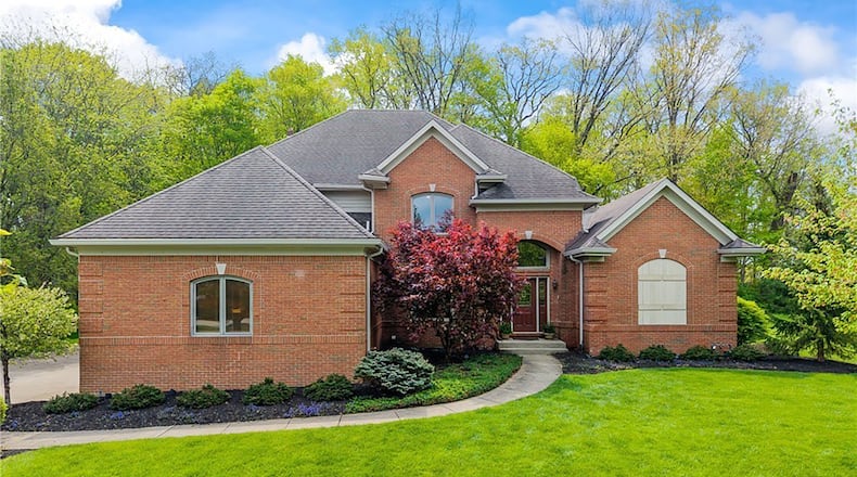 The brick home in Beavercreek Township has a main level primary suite and three additional bedrooms with 5,473 of finished space.