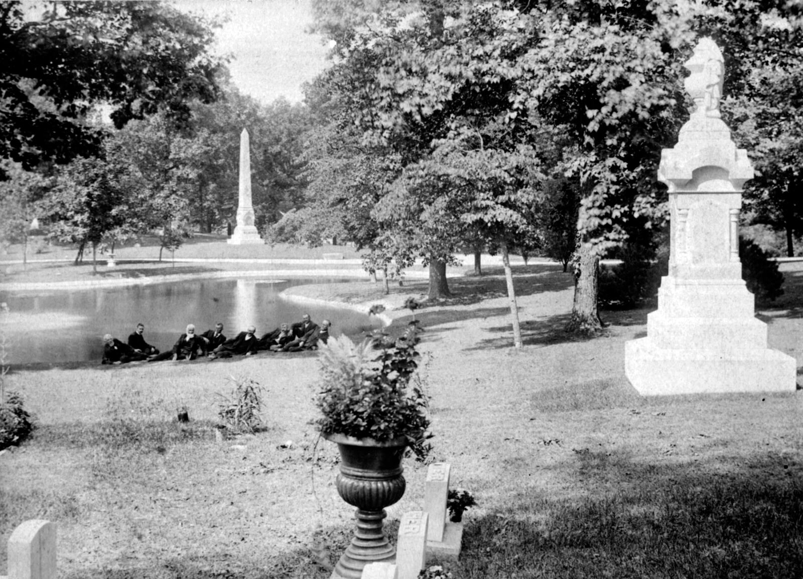 A group of men lounge at the edge of a lake at Woodland Cemetery. Woodland Cemetery and Arboretum is one of the nation's oldest garden cemeteries. WRIGHT STATE UNIVERSITY ARCHIVES