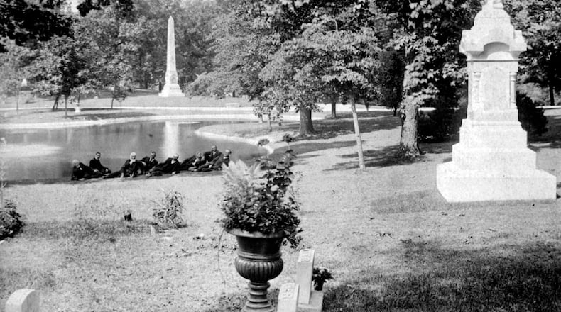 A group of men lounge at the edge of a lake at Woodland Cemetery. Woodland Cemetery and Arboretum is one of the nation's oldest garden cemeteries. WRIGHT STATE UNIVERSITY SPECIAL COLLECTIONS AND ARCHIVE