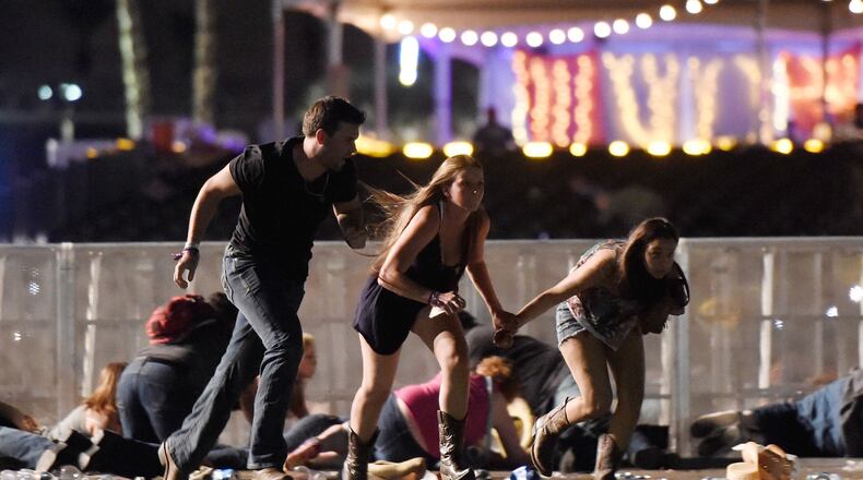 LAS VEGAS, NV - OCTOBER 01: People run from the Route 91 Harvest country music festival after apparent gun fire was hear on October 1, 2017 in Las Vegas, Nevada. A gunman has opened fire on a music festival in Las Vegas, leaving at least 20 people dead and more than 100 injured. Police have confirmed that one suspect has been shot. The investigation is ongoing. (Photo by David Becker/Getty Images)