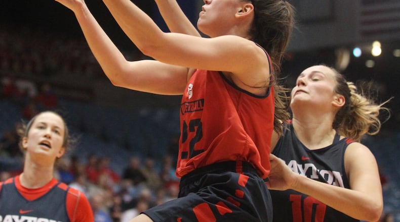 Dayton’s Kelley Austria, center, shoots as she’s guarded by Andi Cvitkovic in the Red and Blue game on Oct. 24, 2015, at UD Arena in Dayton. David Jablonski/Staff