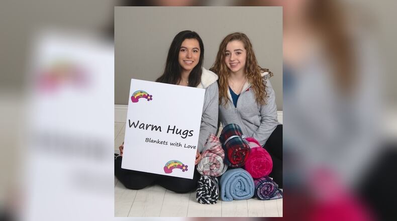 Oakwood eighth-graders Dasha Penas-Johnson (left) and Cecille Figueroa started a Warm Hugs foundation For Hispanic children. CONTRIBUTED