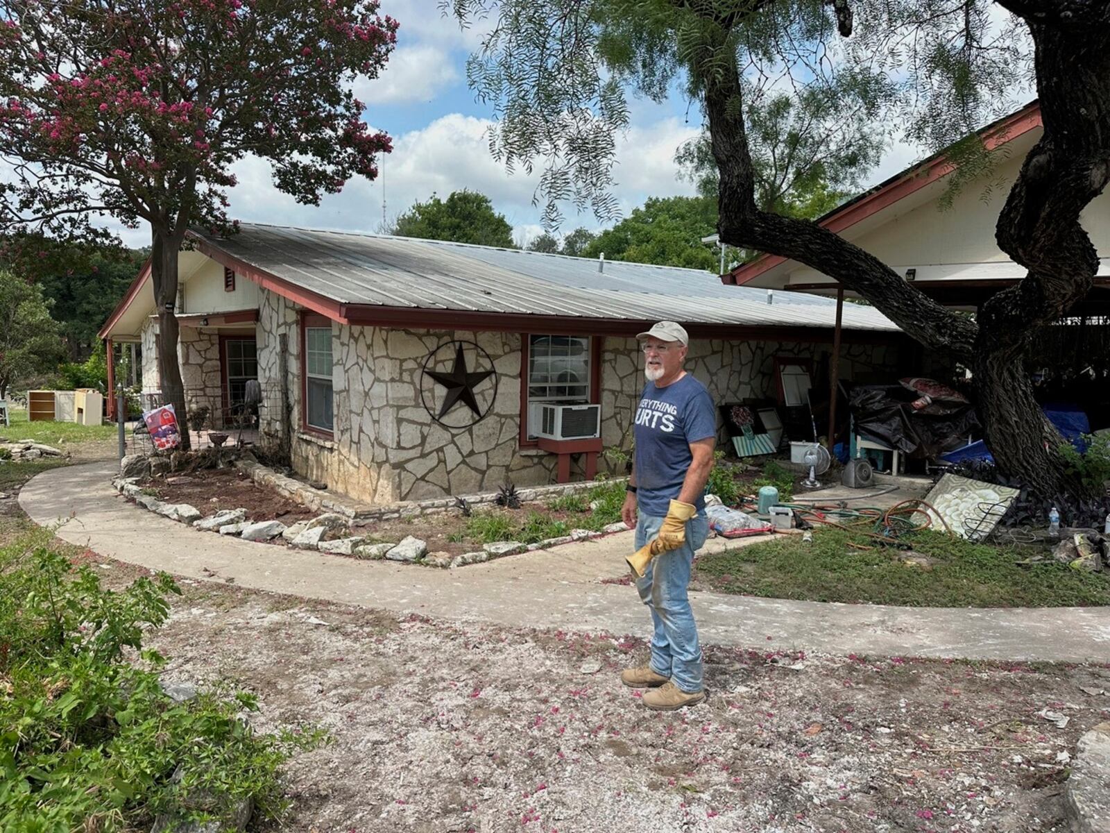 Daniel Olivas stands outside his flood-damaged home in Kerrville, Texas, Saturday, July 12, 2025. (AP Photo/Gabriela Aoun Angueira)