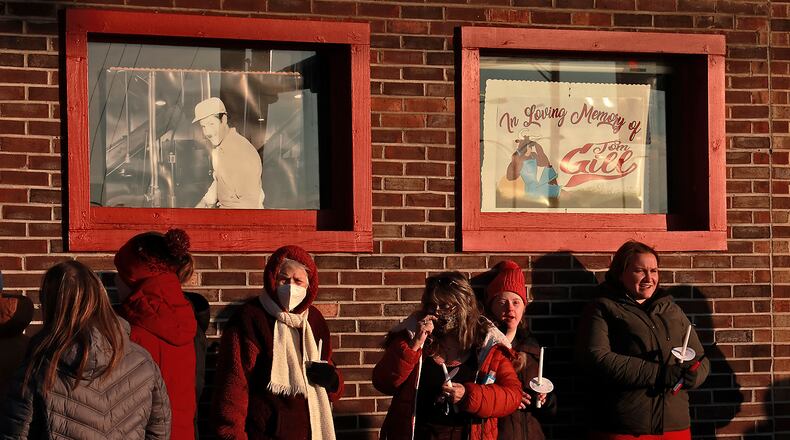 Family, friends and community members fill the parking lot of Gill's Quality Meat Market Monday, Jan. 9, 2023 before the start of a candlelight vigil for Thomas Gill, who was shot and killed last Thursday while driving his SUV in Springfield. BILL LACKEY/STAFF