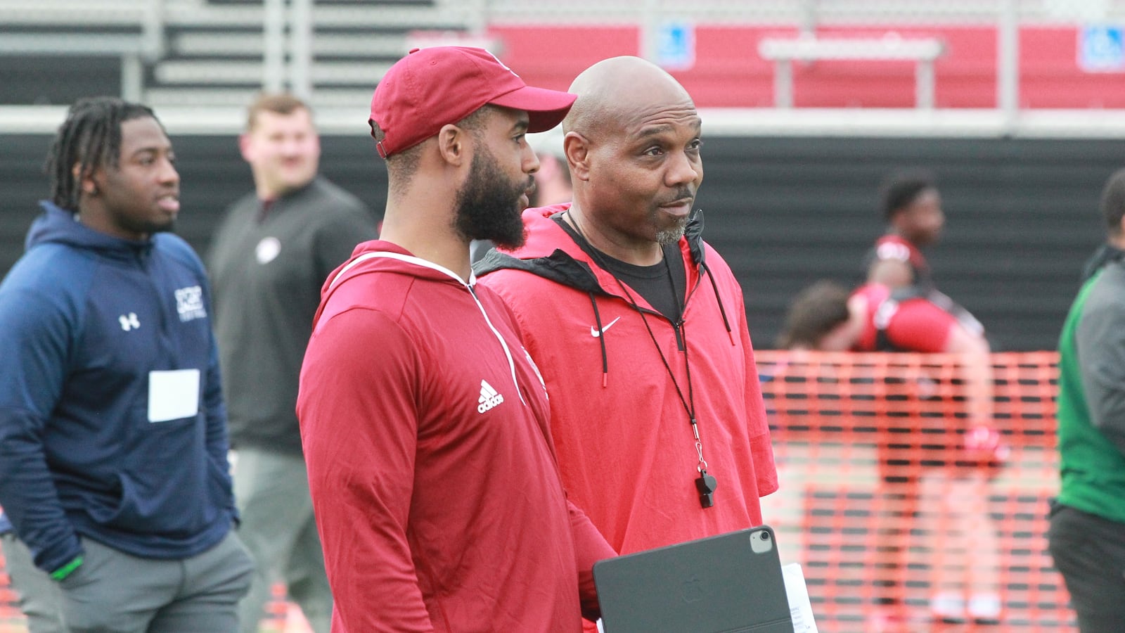 Temple assistant Roy Roundtree (left) and Wayne head coach Roosevelt Mukes during the 2025 GWOC football recruiting showcase in Huber Heights May 5, 2025
