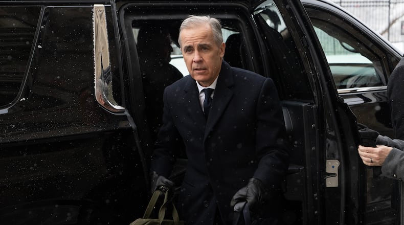 Canadian Prime Minister Mark Carney arrives by motorcade to Parliament Hill in Ottawa, Tuesday, Jan. 27, 2026. (Adrian Wyld/The Canadian Press via AP)