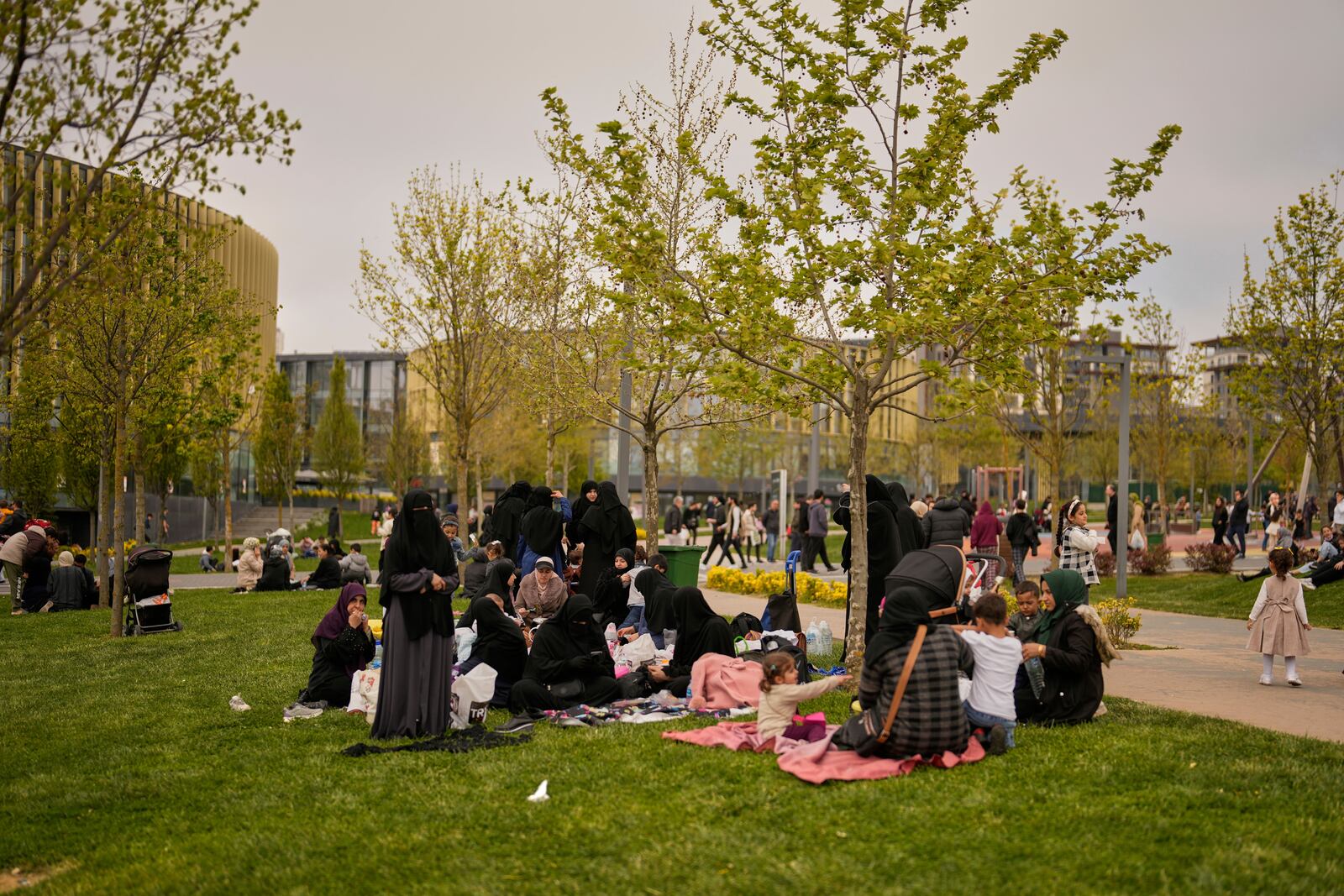 People gather outdoors following an earthquake shock with a preliminary magnitude of 6.2, in Istanbul, Turkey, Wednesday, April 23, 2025. (AP Photo/Khalil Hamra)