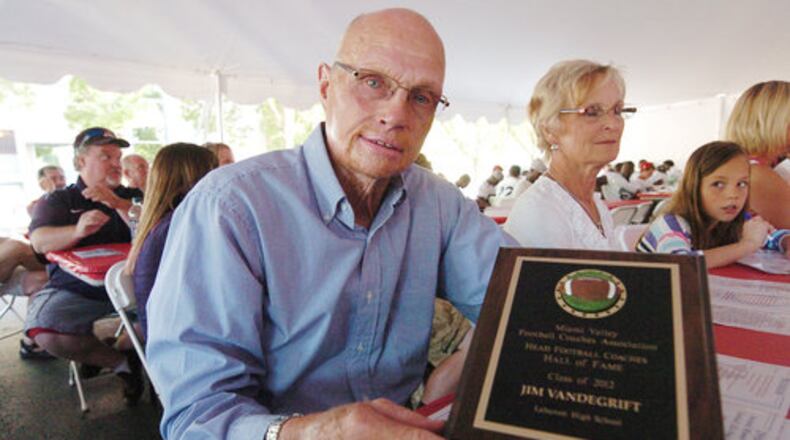 Retired Lebanon High School head football Coach Jim VanDeGrift is seen here with a plaque honoring him as a Miami Valley Coaches Association Head Coaches Hall of Fame inductee at the 10th annual Pigskin Bar-B-Q sponsored by White Allen Chevrolet.