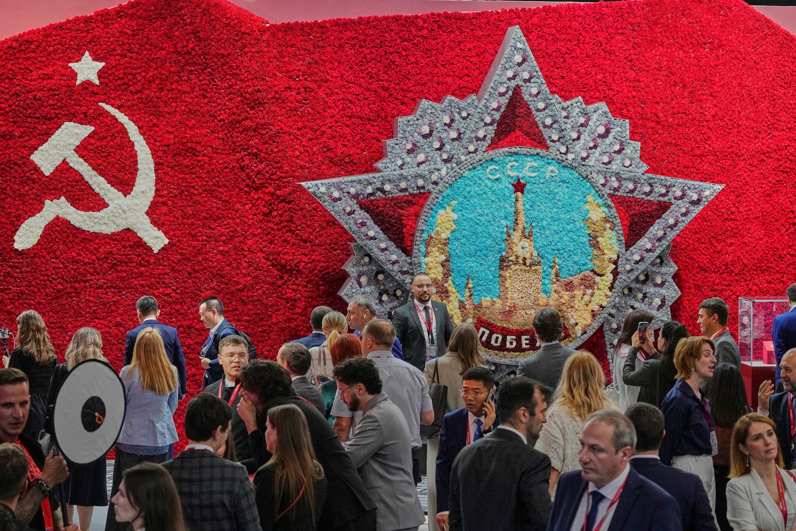Guests and participants walk in front of a model of the Order of Victory on the sidelines of the St. Petersburg International Economic Forum in St. Petersburg, Russia, Wednesday, June 18, 2025. (AP Photo/Dmitri Lovetsky)