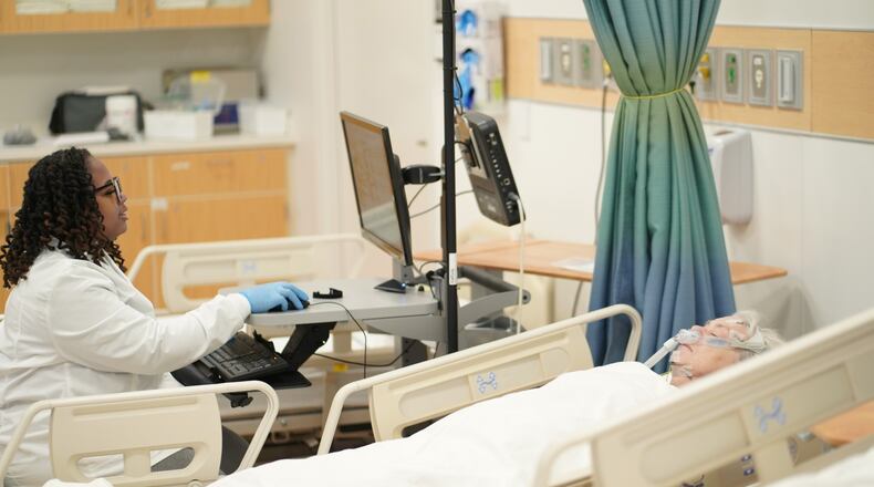 Sinclair Community College polysomnography student Kadijah Blanks practices on faculty member Jane Perri. COURTESY OF SINCLAIR COMMUNITY COLLEGE