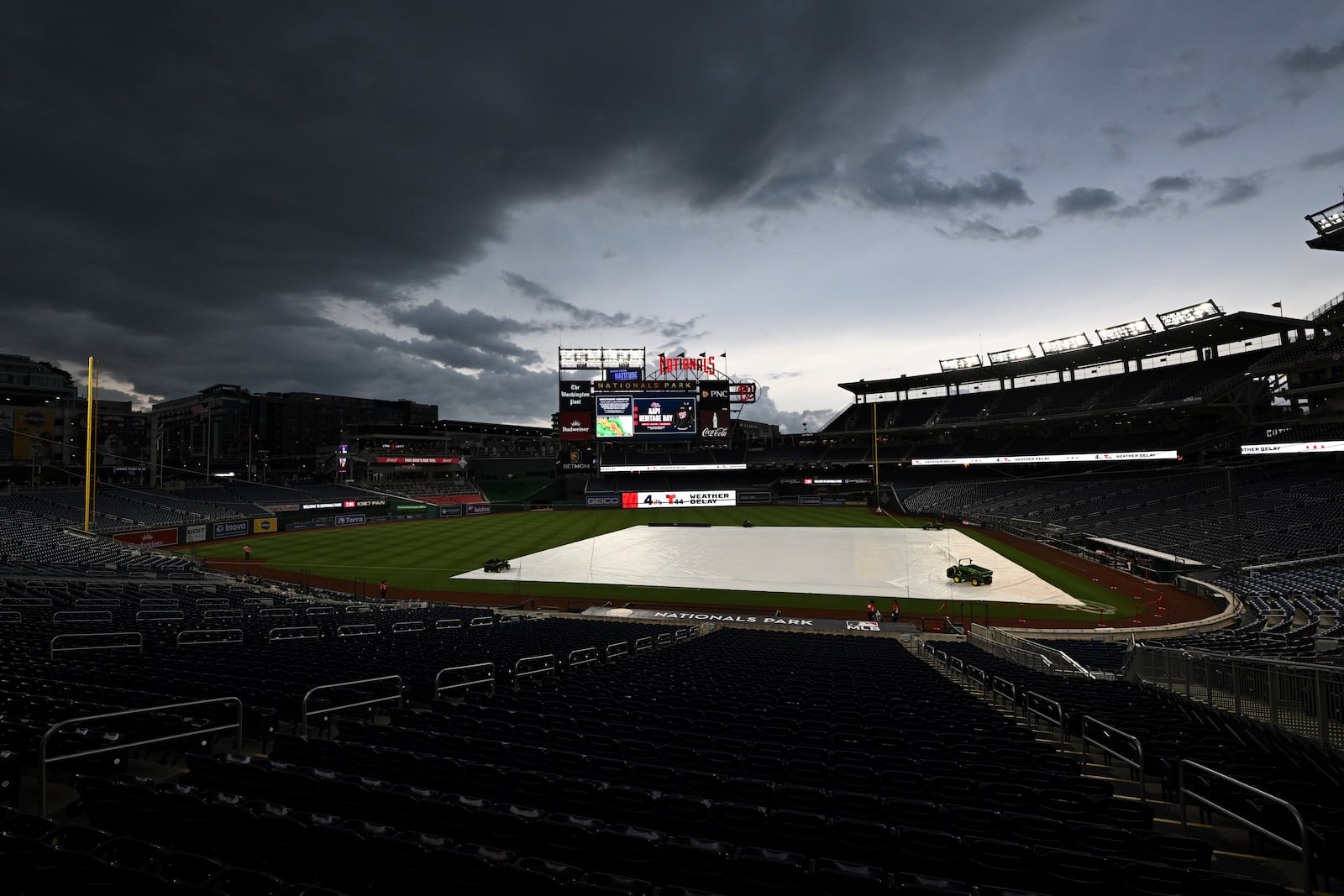 A weather delay is in effect as a tarp protects the field before a baseball game between the Washington Nationals and the Cleveland Guardians in Washington, Monday, May 5, 2025. (AP Photo/Terrance Williams)