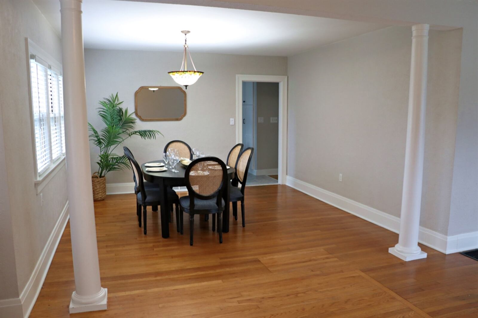 Columns accent the threshold into the dining area.