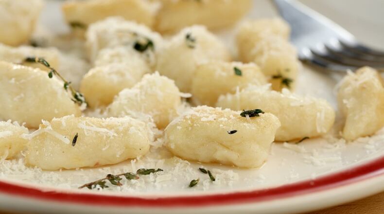 Serve the gnocchi with your favorite sauce. Here, they are coated with fresh sage and butter and sprinkled with Parmesan cheese. (Michael Tercha/Chicago Tribune/TNS)