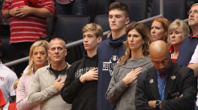 Lukas Frazier (third from left) watches a Dayton game against Fort Wayne on Nov. 16, 2018, from behind the UD bench at UD Arena.