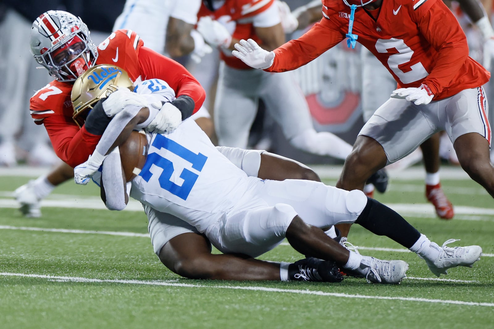 Ohio State defensive lineman Kenyatta Jackson, top, tackles UCLA running back Jaivian Thomas during the first half of an NCAA college football game, Saturday, Nov. 15, 2025, in Columbus, Ohio. (AP Photo/Jay LaPrete)