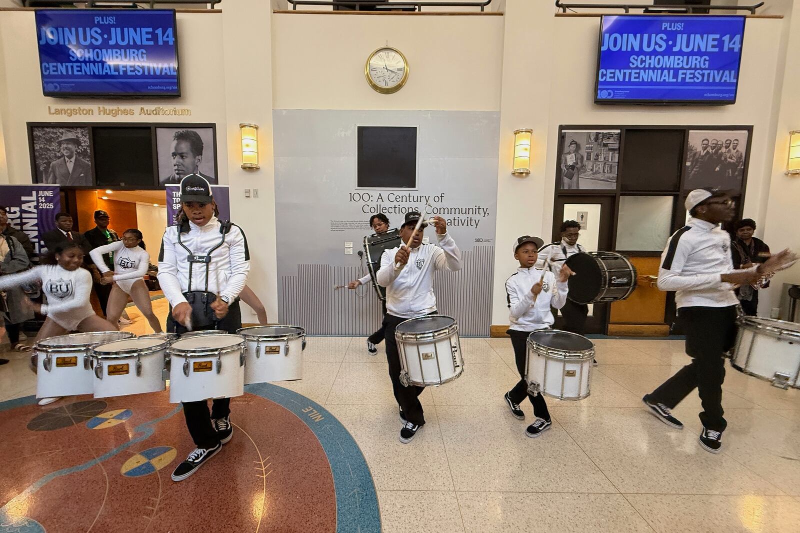 Brooklyn United Marching Band kicks in the Langston Hughes Auditorium celebrating the centennial of the Schomburg Center for Research in Black Culture in New York on Saturday, June 14, 2025. (AP Photo/Jaylen Green)