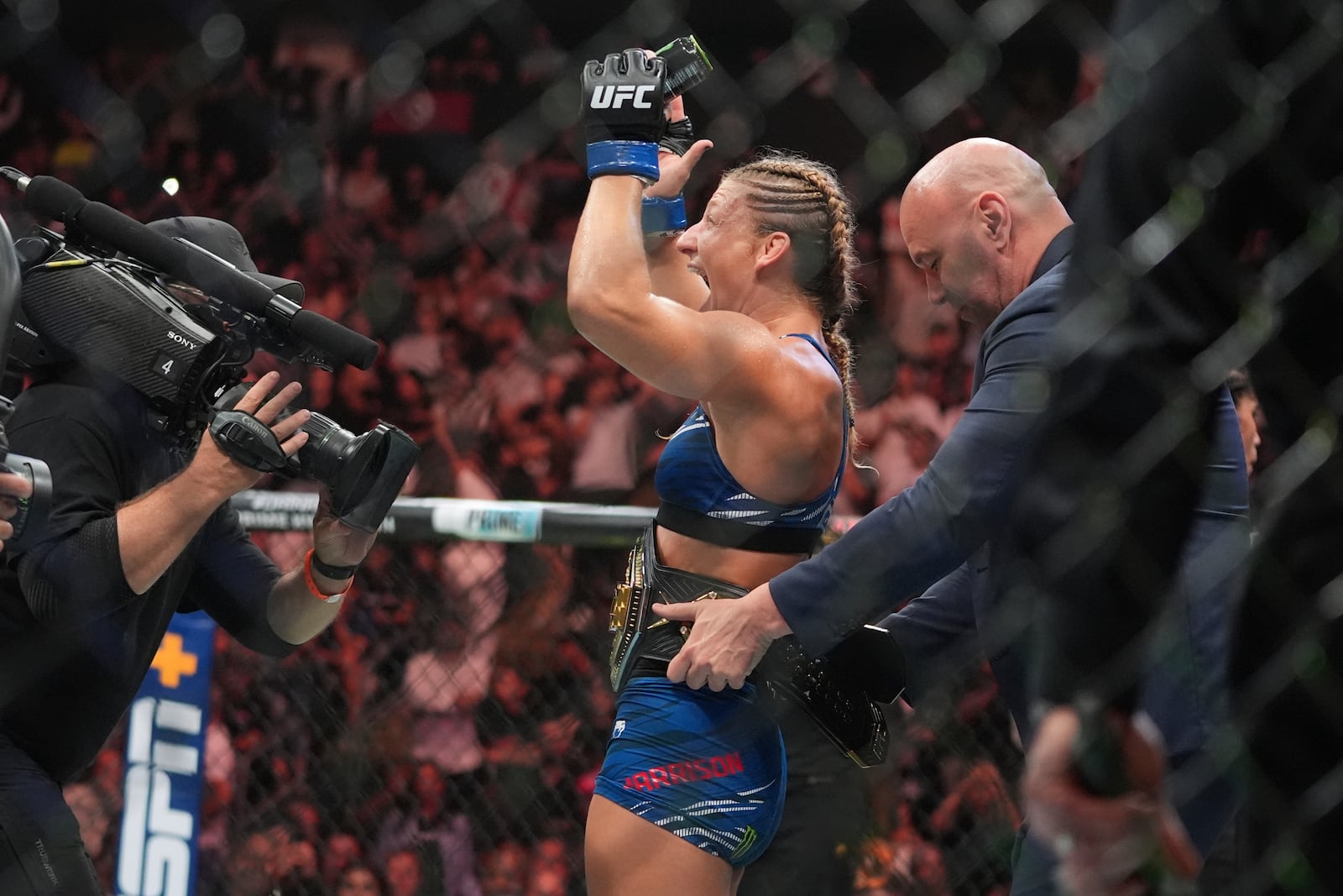 Kayla Harrison celebrates after winning her women's bantamweight bout against Julianna Peña at the UFC 316 mixed martial arts event Sunday, June 8, 2025 in Newark, N.J. (AP Photo/Frank Franklin II)