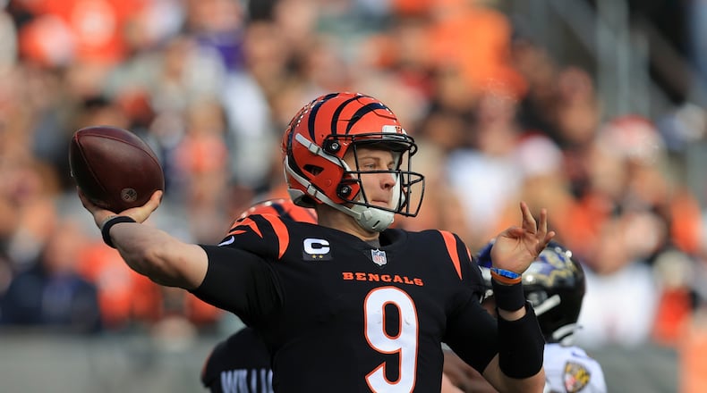 Cincinnati Bengals quarterback Joe Burrow (9) throws during the first half of an NFL football game against the Baltimore Ravens, Sunday, Dec. 26, 2021, in Cincinnati. (AP Photo/Aaron Doster)