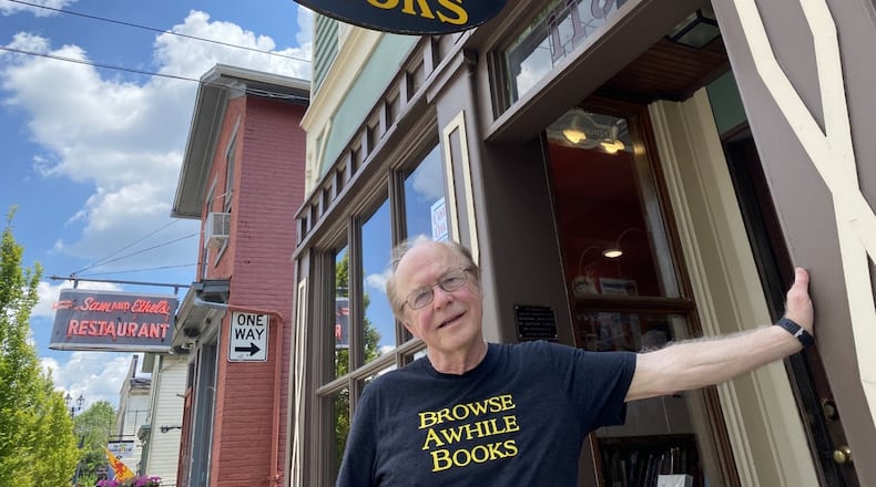 Bill Jones, owner of Browse Awhile Books, stands outside his shop in Tipp City.