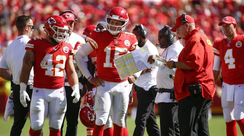 KANSAS CITY, MO - SEPTEMBER 23: Patrick Mahomes #15 of the Kansas City Chiefs and teammate Anthony Sherman #42 stand with head coach Andy Reid and offensive coordinator Eric Bieniemy in the fourth quarter of the game against the San Francisco 49ers at Arrowhead Stadium on September 23rd, 2018 in Kansas City, Missouri. (Photo by David Eulitt/Getty Images)