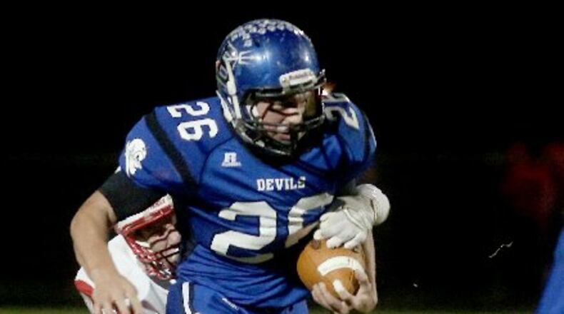 Bailey Wallen (with ball) led Brookville over Carlisle 41-0 in a D-V first-round playoff game last season. EL HUBBARD PHOTO