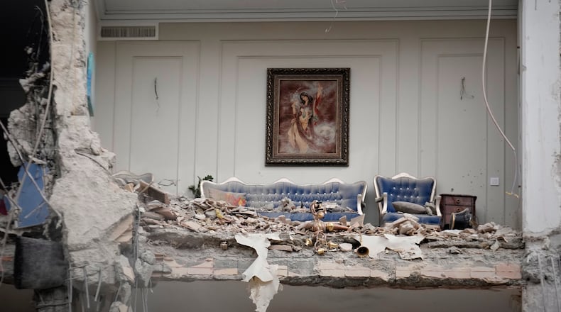 Rubble covers the furniture of a destroyed living room in a residential building hit in an earlier U.S.-Israeli strike in Tehran, Iran, Monday, March 23, 2026. (AP Photo/Vahid Salemi)