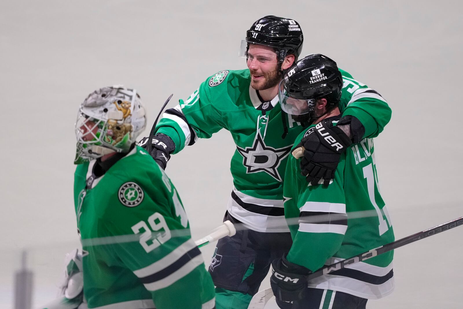 Dallas Stars center Colin Blackwell, right, is congratulated by teammates center Tyler Seguin (91) and goaltender Jake Oettinger (29) after scoring the game-winning goal against the Colorado Avalanche during overtime in Game 2 of a first-round NHL hockey playoff series early Tuesday, April 22, 2025, in Dallas. (AP Photo/Julio Cortez)