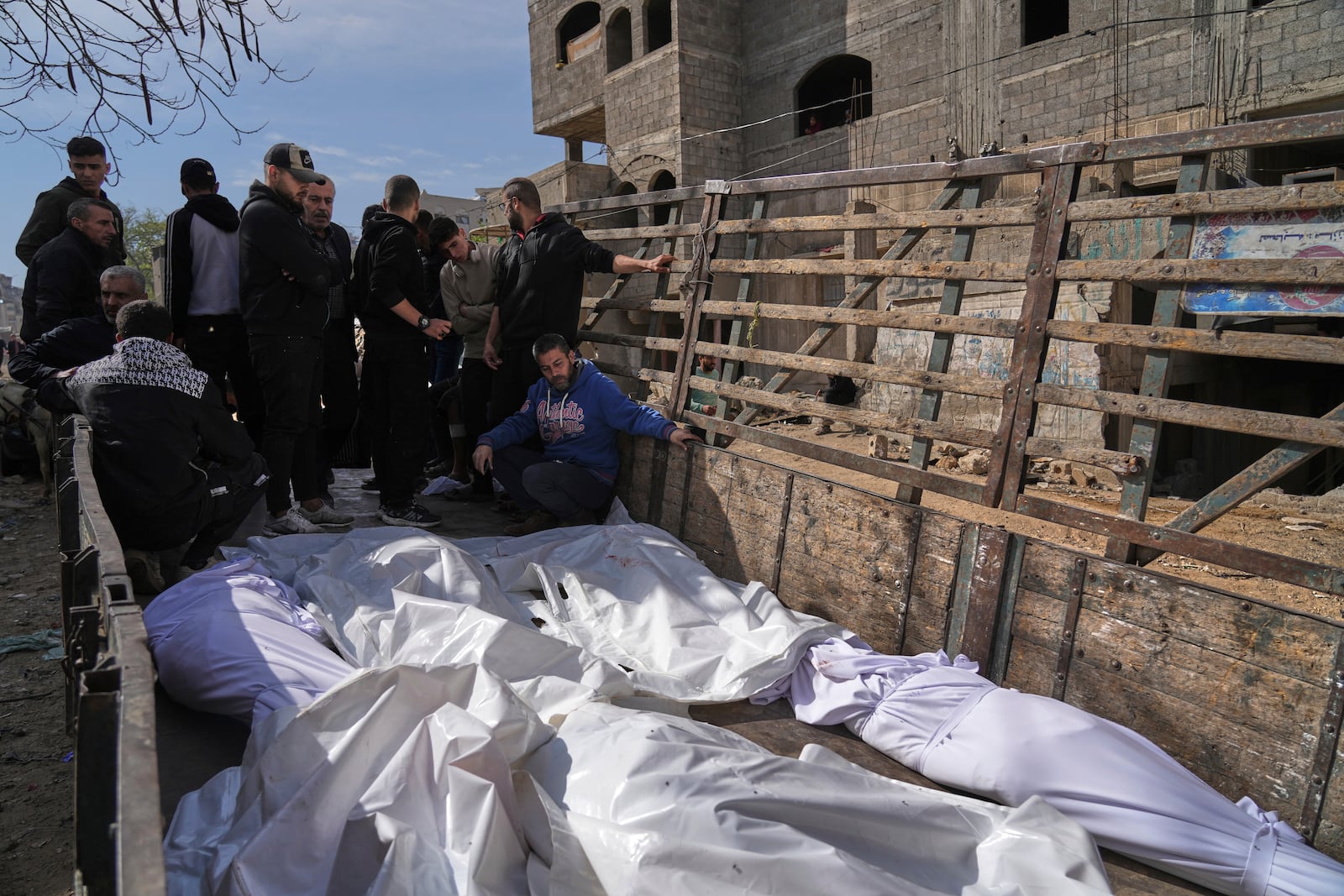 Palestinians accompany the bodies of their relatives killed in an Israeli airstrike, loaded onto a truck in preparation for burial, at Shifa Hospital in Gaza City, Wednesday, April 16, 2025. (AP Photo/Jehad Alshrafi)