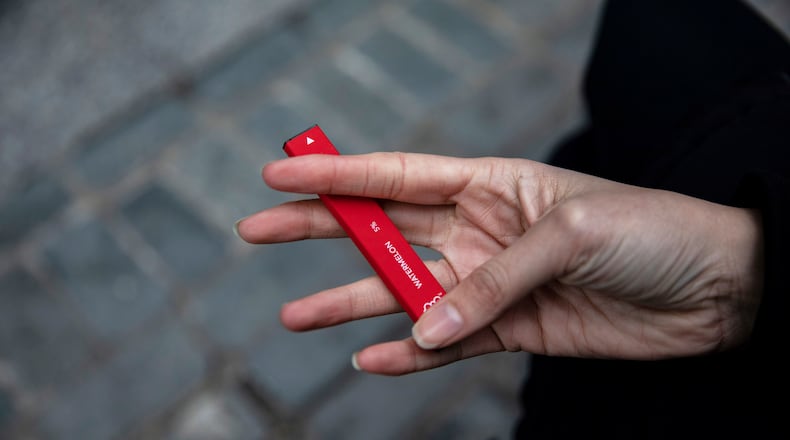 FILE - In this Jan. 31, 2020 photo a woman holds a flavored disposable vape device in New York. A government study on adolescent vaping, released on Thursday, Oct. 6, 2022, finds more than 2.5 million U.S. kids were using some form of e-cigarette in 2022, suggesting there’s been little progress in keeping vaping devices out of the hands of teenagers. (AP Photo/Marshall Ritzel, File)