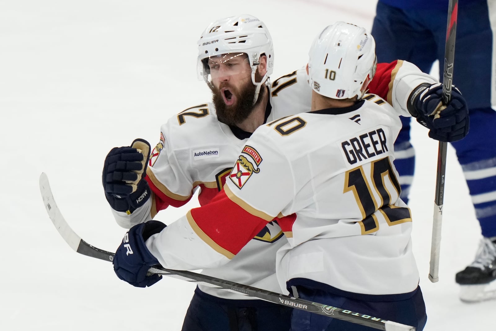 Florida Panthers' A.J. Greer (10) celebrates his goal with teammate Jonah Gadjovich (12) during third period NHL playoff hockey action against the Toronto Maple Leafs, in Toronto on Wednesday, May 14, 2025. (Frank Gunn/The Canadian Press via AP)