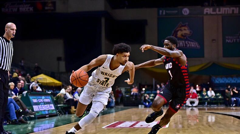 Wright State’s Mark Hughes tries to drive around UIC’s Marcus Ottey during Friday’s game at the Nutter Center. Josepth Craven/CONTRIBUTED