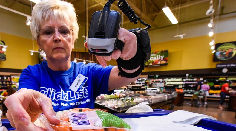 Carol Spencer collects an online grocery order for the Clicklist store pickup Thursday, Sept. 8 at Kroger Marketplace on Yankee Road in Liberty Township. Customers can order their groceries online and pay and get their order loaded into their car by Kroger staff. NICK GRAHAM/STAFF