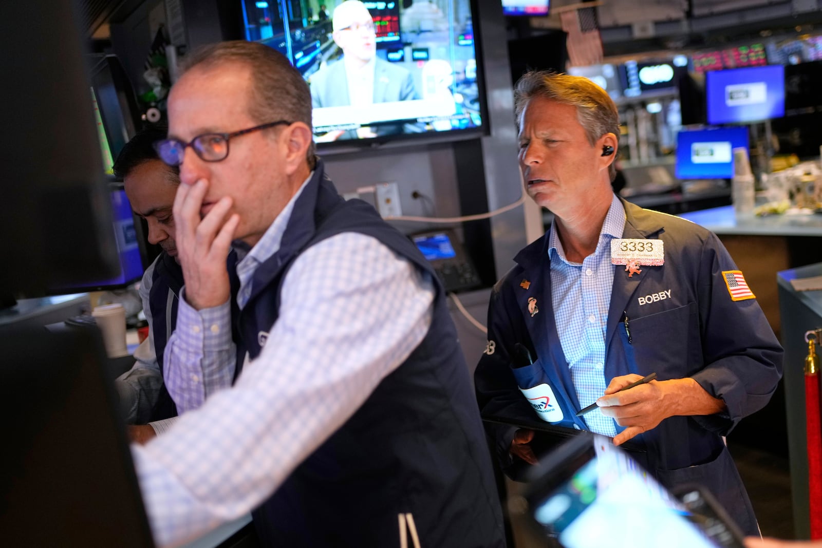 Bobby Charmak, right, works on the floor at the New York Stock Exchange in New York, Wednesday, April 30, 2025. (AP Photo/Seth Wenig)