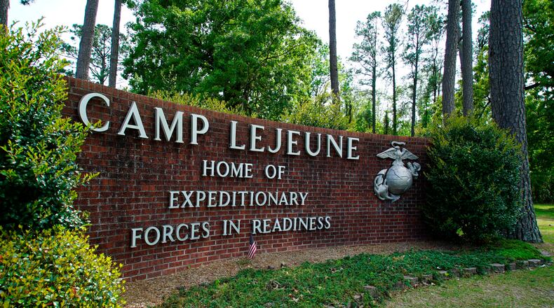 FILE - Signage stands on the main gate to Camp Lejeune Marine Base outside Jacksonville, N.C., on April 29, 2022. A Marine was killed in a homicide at Camp Lejeune on Wednesday night, Oct. 18, 2023, and a second Marine was held on suspicion of being involved, the base said. (AP Photo/Allen G. Breed, File)