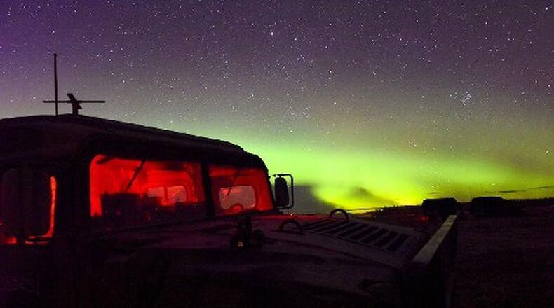 A U.S. Air Force Humvee, assigned to Det. 1, 3rd Air Support Operations Squadron sits under the Aurora Borealis, Oct. 9, 2018, in the Donnelly Training Area, Alaska. (U.S. Air Force photo by Senior Airman Isaac Johnson/CONTRIBUTED)