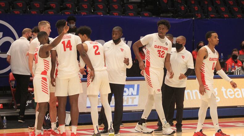 Dayton huddles during the final minute of a game against Southern Methodist on Saturday, Dec. 5, 2020, at UD Arena. David Jablonski/Staff