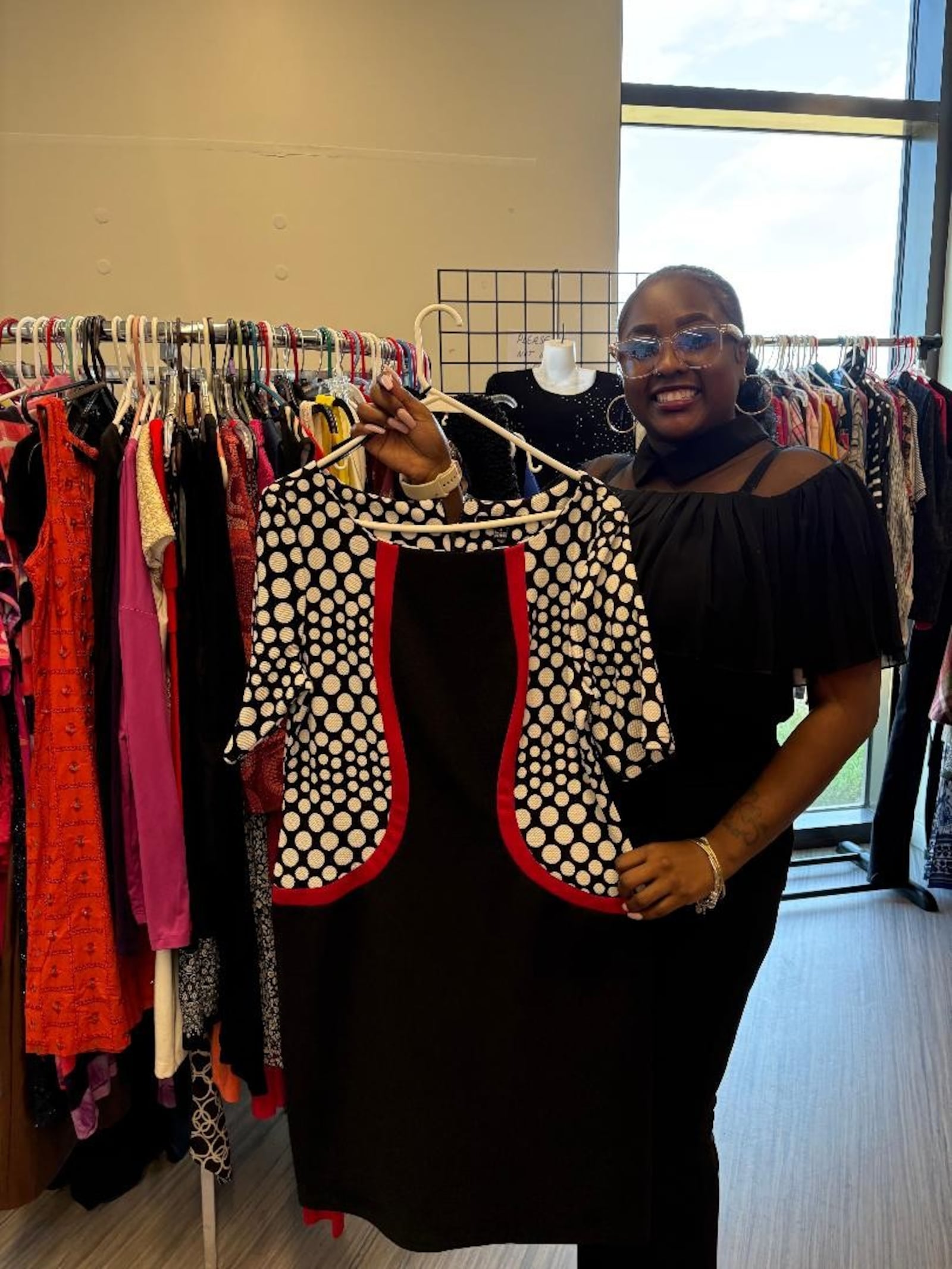 "When you look good, you feel good," said Latoya Priest, pictured here showcasing a dress within the women's collection of the Essence of West Boutique. Photo by Russell Florence Jr.
