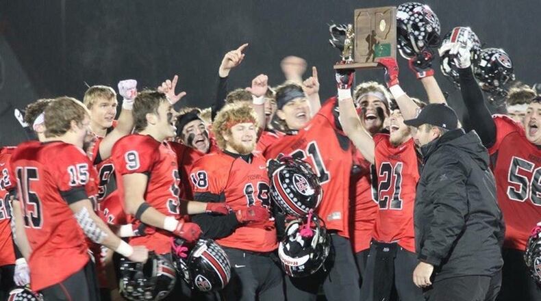 Fort Loramie coach Spencer Wells and the Redskins celebrate a 48-20 D-VII, Region 28 championship defeat of Convoy Crestview at Lima on Saturday, Nov. 17, 2018. CONTRIBUTED PHOTO