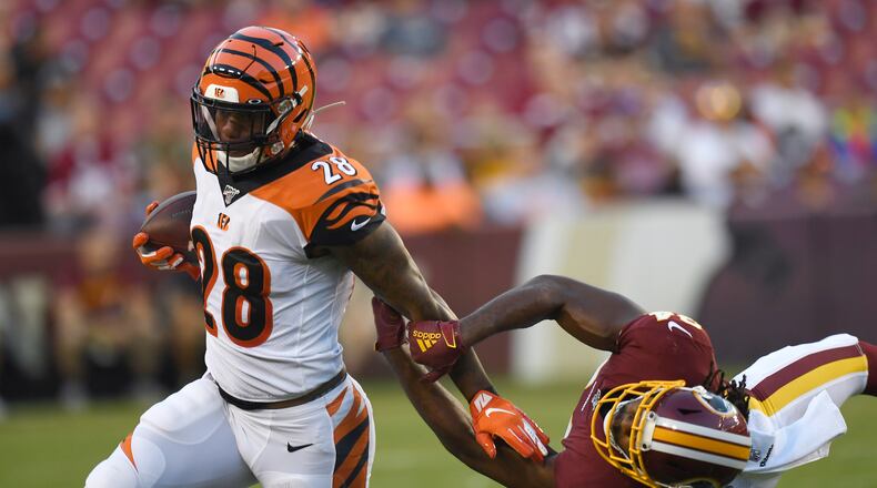 Cincinnati Bengals running back Joe Mixon (28) runs past Washington Redskins cornerback Josh Norman, right, during the first quarter of an NFL preseason football game in Landover, Md., Thursday, Aug. 15, 2019. (AP Photo/Susan Walsh)