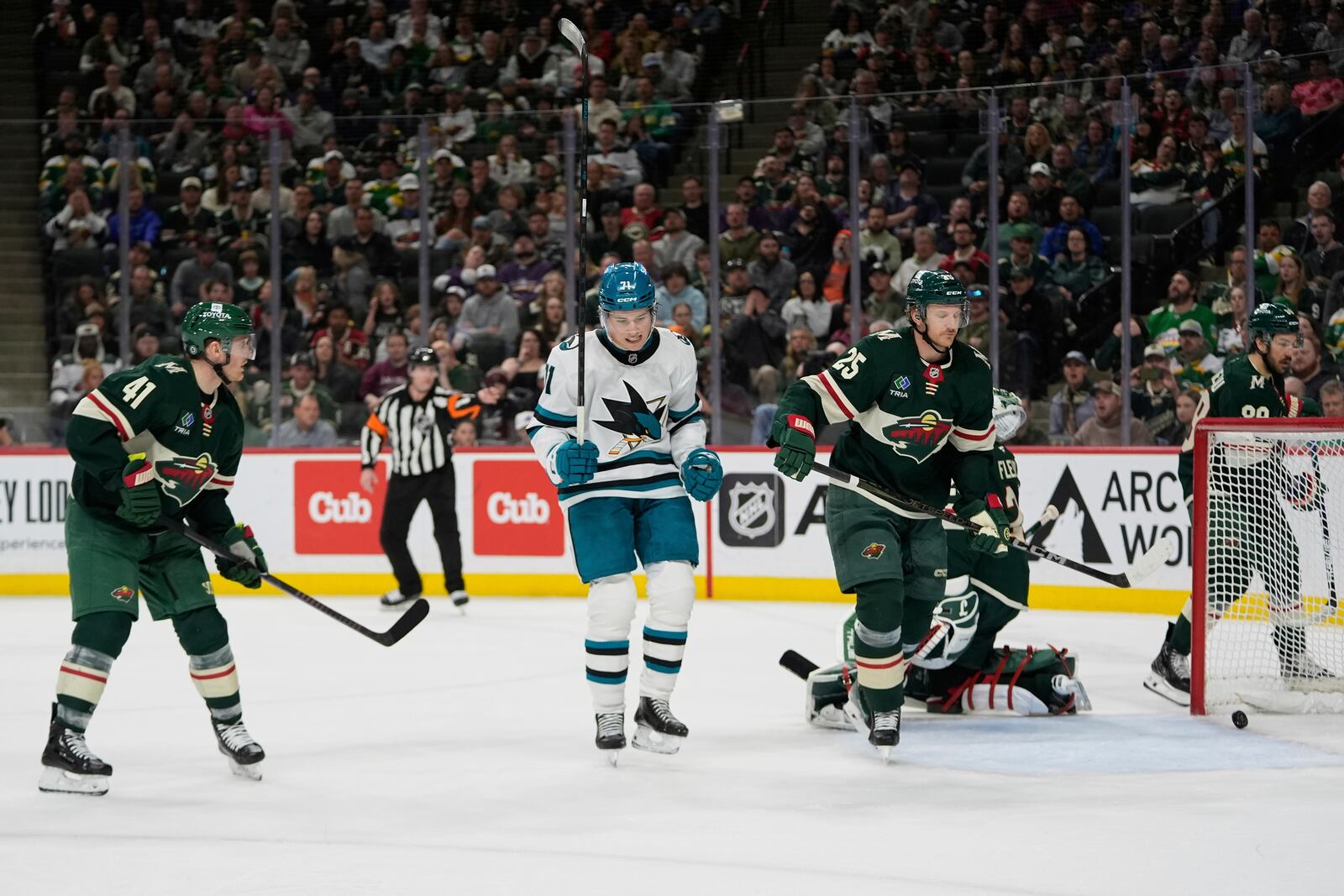 San Jose Sharks center Macklin Celebrini (71), middle, celebrates after scoring a goal during the second period of an NHL hockey game against the Minnesota Wild, Wednesday, April 9, 2025, in St. Paul, Minn. (AP Photo/Abbie Parr)