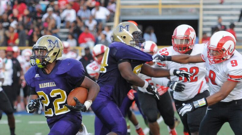 In this file photo, Thurgood running back Daryl McCleskey (22) eludes the Trotwood defense. Thurgood Marshall hosted Trotwood-Madison in a high school football game at Welcome Stadium on Saturday, Sept. 6, 2014. MARC PENDLETON / STAFF