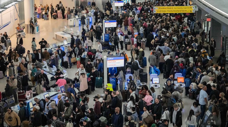 People wait in a TSA line at the John F. Kennedy International Airport, Sunday, March 22, 2026, in New York. (AP Photo/Yuki Iwamura)